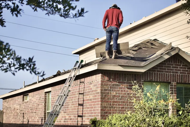Professional roofer working on a residential roof in North Lake Wire
